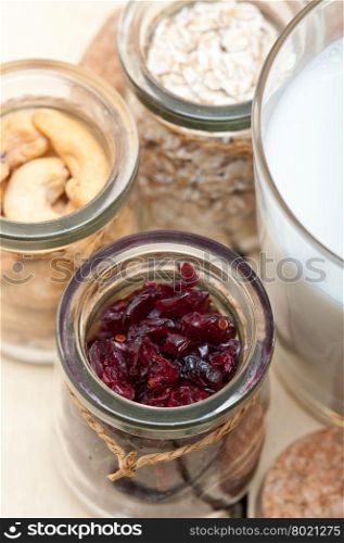 healthy breakfast ingredients milk oat cashew nuts dried cramberry craisinns