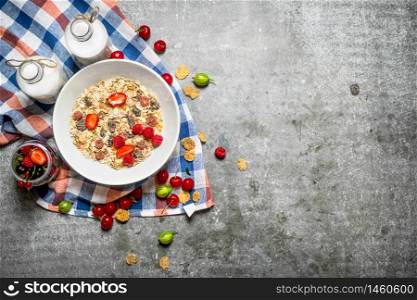 Healthy Breakfast. Muesli with cherries, strawberries and milk. On the stone table.. Healthy Breakfast. Muesli with cherries, strawberries and milk