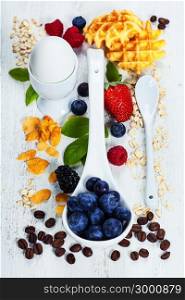 Healthy Breakfast.Oat flake, berries and coffee on wooden table. Health and diet concept