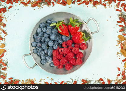 Healthy breakfast of berries and superfoods on blue background - Healthy food, Diet, Detox, Clean Eating or Vegetarian concept