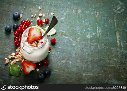Healthy breakfast of muesli, berries with yogurt and seeds on dark background - Healthy food, Diet, Detox, Clean Eating or Vegetarian concept.