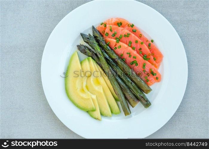 Healthy breakfast of salmon, avocado and asparagus