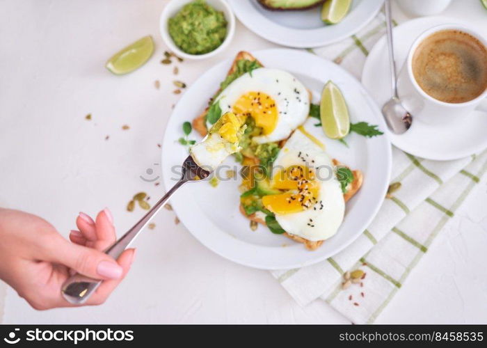 healthy breakfast or snack - sliced avocado and fried egg on toasted bread and cup of coffee.. healthy breakfast or snack - sliced avocado and fried egg on toasted bread and cup of coffee