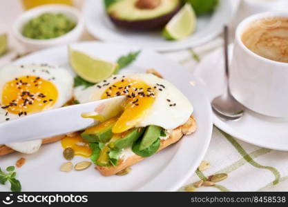 healthy breakfast or snack - sliced avocado and fried egg on toasted bread and cup of coffee.. healthy breakfast or snack - sliced avocado and fried egg on toasted bread and cup of coffee