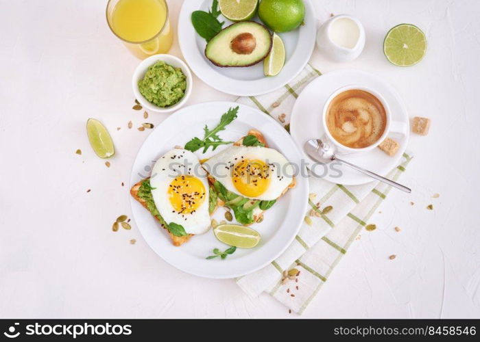 healthy breakfast or snack - sliced avocado and fried egg on toasted bread and cup of coffee.. healthy breakfast or snack - sliced avocado and fried egg on toasted bread and cup of coffee