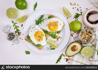 healthy breakfast or snack - sliced avocado and fried egg on toasted bread.. healthy breakfast or snack - sliced avocado and fried egg on toasted bread 