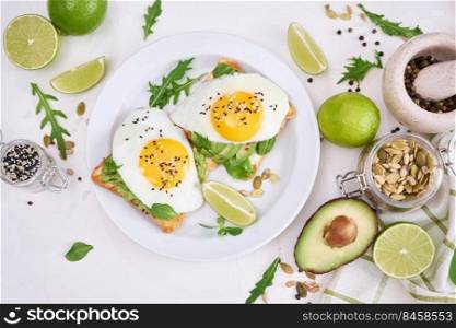 healthy breakfast or snack - sliced avocado and fried egg on toasted bread.. healthy breakfast or snack - sliced avocado and fried egg on toasted bread 