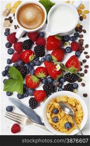 Healthy Breakfast with coffee, corn flakes, milk and berry on old wooden background. Health and diet concept