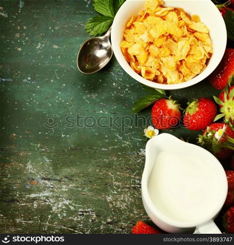Healthy Breakfast with corn flakes, milk and strawberry on old wooden background. Health and diet concept