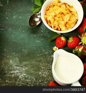 Healthy Breakfast with corn flakes, milk and strawberry on old wooden background. Health and diet concept