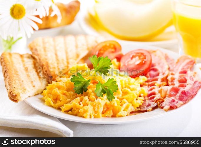 healthy breakfast with scrambled eggs, juice and fruits