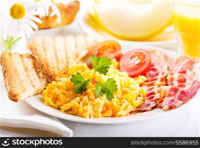 healthy breakfast with scrambled eggs, juice and fruits