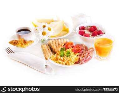 healthy breakfast with scrambled eggs, juice and fruits on white background
