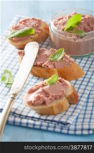 healthy chicken liver pate with sage in jar and on bread