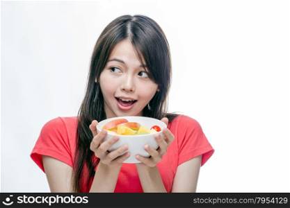 Healthy Chinese woman holding bowl of fruit