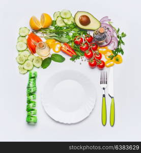 Healthy clean eating or diet food concept. Various salad vegetables with white plate , cutlery and green measuring tape on white background, top view, flat lay, frame.