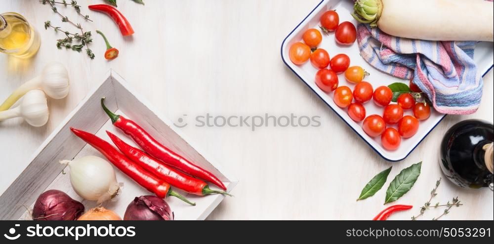 Healthy , clean food or vegetarian cooking and eating concept with various vegetables, oil and spices on white wooden background, top view, banner