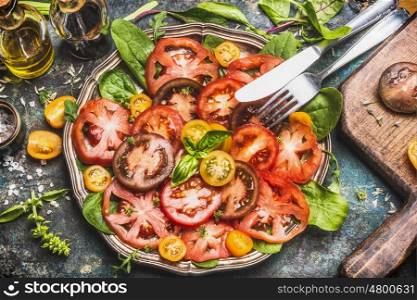 Healthy colorful tomatoes salad with cutlery , top view, banner