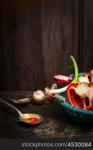 healthy cooking with fresh organic vegetables and oil. Scene on rustic kitchen table over wooden background. Healthy food concept