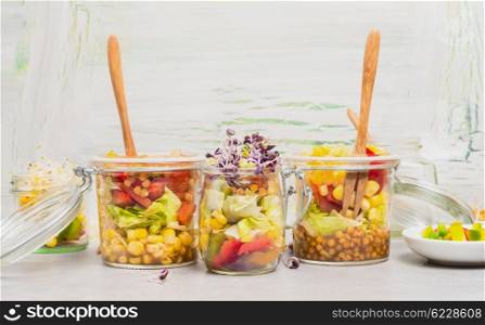 Healthy corn and lentil salads with sprouts in glass jars. Healthy lifestyle or diet food concept