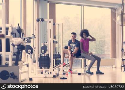healthy couple have break at crossfit gym african american woman with afro hairstyle