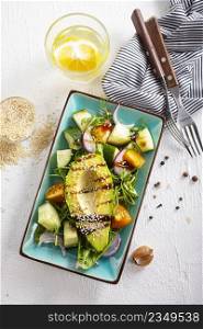 Healthy cuisine. Fresh green salad with avocado