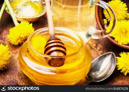 healthy dandelion honey. Honey from a blooming spring dandelion and cup of tea.Dandelion jam