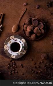 healthy delicious chocolate truffles around ingridients with natural cocoa beans, powder, cacao butter, cane sugar and cup of coffee. healthy sweets concept. flat lay