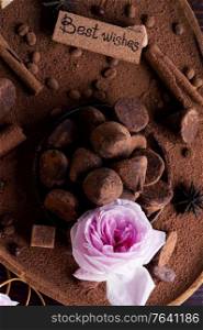 healthy delicious chocolate truffles around ingridients with natural cocoa powder, cacao butter, cane sugar and rose. healthy sweets concept. flat lay
