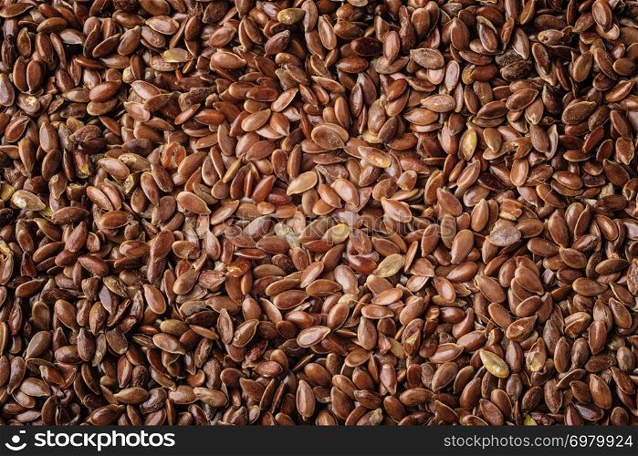 Healthy diet organic nutrition. Brown raw flax seeds linseed as natural food background