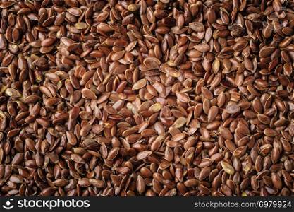 Healthy diet organic nutrition. Brown raw flax seeds linseed as natural food background
