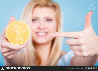 Healthy diet, refreshing food full of vitamins. Woman holding sweet delicious citrus fruit, lemon on orange.. Woman holding fruit lemon or orange