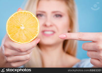 Healthy diet, refreshing food full of vitamins. Woman holding sweet delicious citrus fruit, lemon on orange.. Woman holding fruit lemon or orange