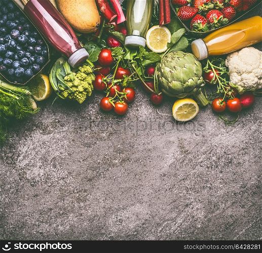 Healthy dieting and antioxidant beverages background with various colorful organic vegetables, fruits and berries smoothies with ingredients in bottles on gray granite table , top view with copy space