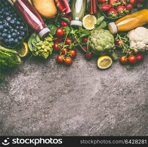 Healthy dieting and antioxidant beverages background with various colorful organic vegetables, fruits and berries smoothies with ingredients in bottles on gray granite table , top view with copy space