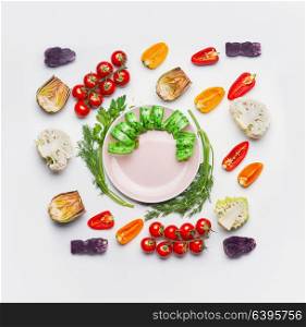 Healthy eating and dieting concept. Plate with measuring tape on table with vegetables on white background, top view. Food flat lay