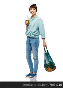 healthy eating and sustainability concept - asian woman drinking smoothie from plastic cup and holding reusable string bag with fruits and vegetables over white background. asian woman with drink and food in reusable bag