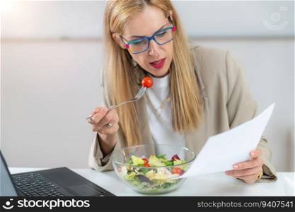 Healthy eating at work. Woman indulges in a delightful fresh salad at her workplace. With every bite, she embraces the nourishing flavors and invigorating energy of her nutritious meal, fueling her day with a refreshing and health-conscious choice. Woman Eating Fresh Salad at Workplace