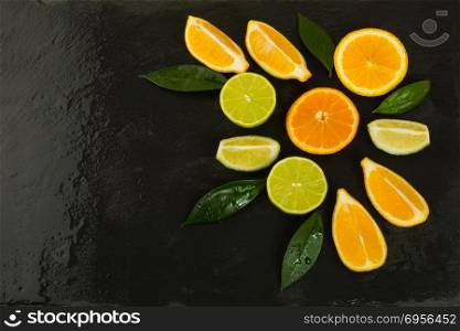 Healthy eating concept citrus on the black background. Fresh food. Ripe fruit. Citrus fruit. Vegetarian food. Fresh fruit. Mixed fruit. Fruit background. Healthy eating concept. Healthy eating concept citrus on the black background