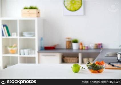 healthy eating, cooking and interior concept - modern home kitchen with food on table. modern home kitchen interior with food on table