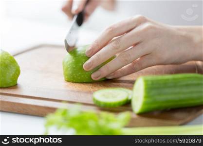 healthy eating, cooking, vegetarian food, dieting and people concept - close up of young woman hands chopping green vegetables