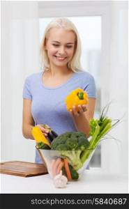 healthy eating, cooking, vegetarian food, dieting and people concept - smiling young woman with bowl of vegetables at home