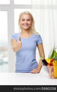 healthy eating, cooking, vegetarian food, dieting and people concept - smiling young woman with bowl of vegetables at home showing thumbs up
