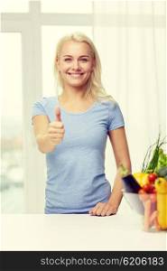 healthy eating, cooking, vegetarian food, dieting and people concept - smiling young woman with bowl of vegetables at home showing thumbs up