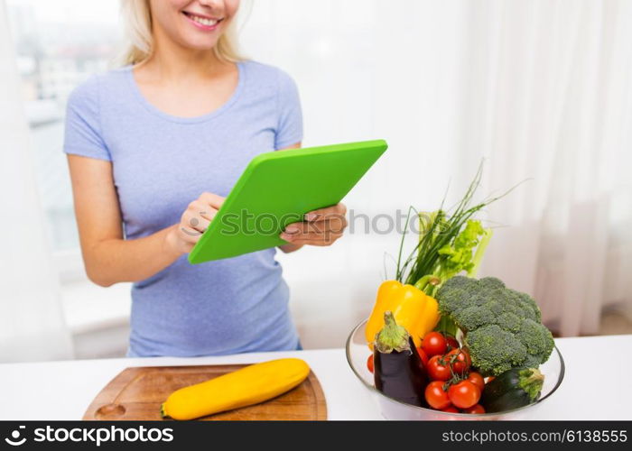 healthy eating, cooking, vegetarian food, technology and people concept - close up of smiling young woman with tablet pc computer and bowl of vegetables at home