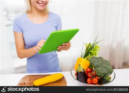 healthy eating, cooking, vegetarian food, technology and people concept - close up of smiling young woman with tablet pc computer and bowl of vegetables at home