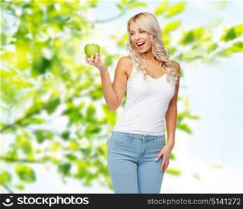 healthy eating, diet and people concept - happy beautiful young woman with green apple over natural summer background. happy beautiful young woman with green apple