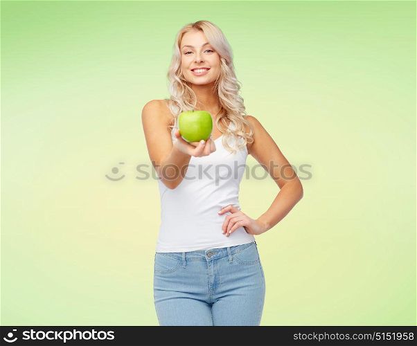 healthy eating, diet and people concept - happy beautiful young woman with apple over green background. happy beautiful young woman with green apple