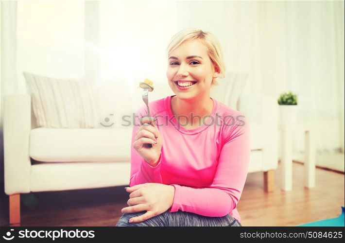 healthy eating, dieting and people concept - smiling young woman eating vegetable salad at home. smiling young woman eating salad at home. smiling young woman eating salad at home