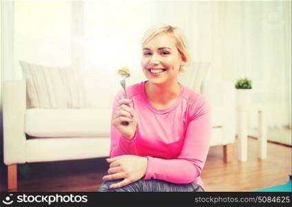 healthy eating, dieting and people concept - smiling young woman eating vegetable salad at home. smiling young woman eating salad at home. smiling young woman eating salad at home